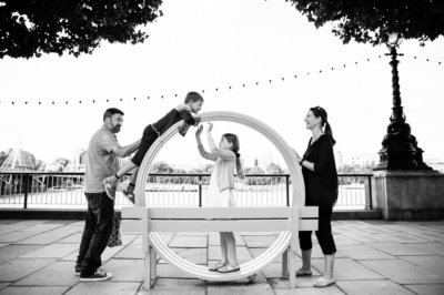 A family portrait on London's south bank with a bench.