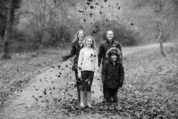 A family portrait with autumn leaves.