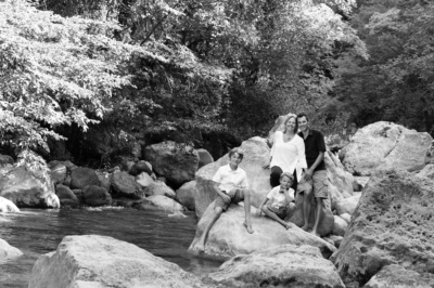 Family portraits next to a stream.