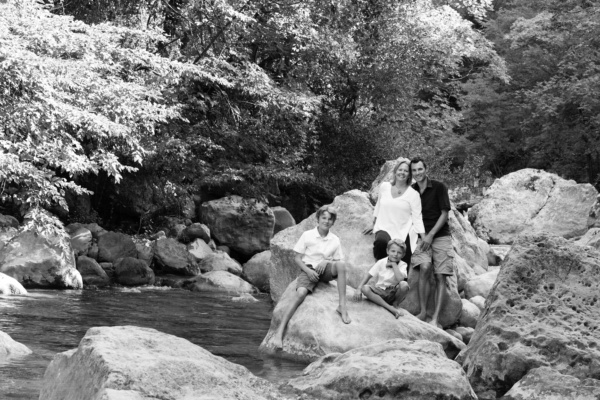 Family portraits next to a stream.