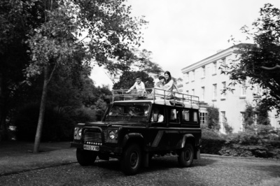 A family rides on top of a Land Rover.