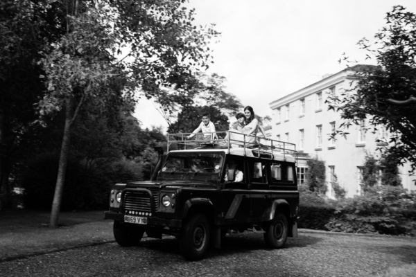 A family rides on top of a Land Rover.