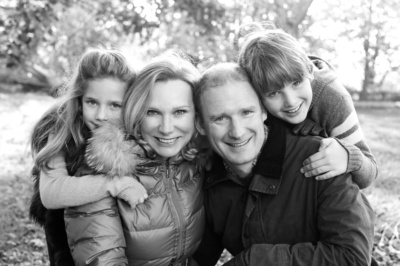 A family snuggles together in a park.