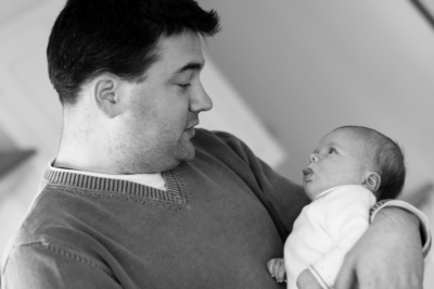 A father holds his newborn child.