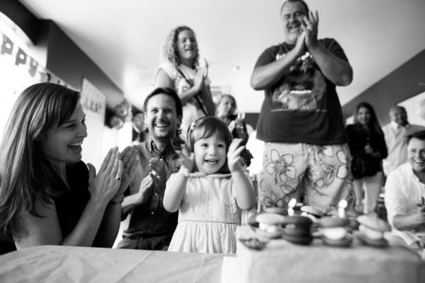 A girl and her family celebrate her birthday.