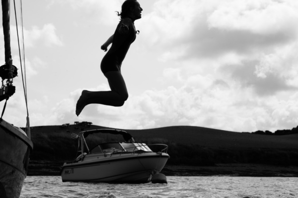 A girl jumps off a boat.