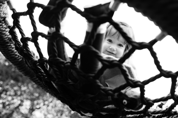 A girl swings on a rope swing.