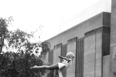 A girl poses as a bird near London's Tate Modern.