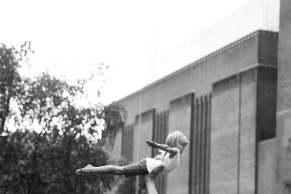 A girl poses as a bird near London's Tate Modern.