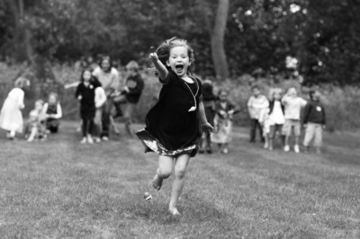 A girl races across the grass.