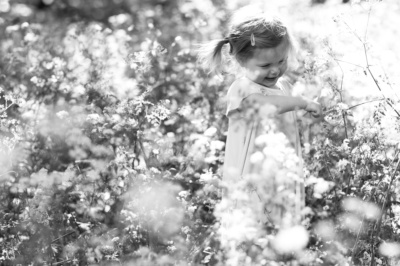 Girl runs through a wildflower field.