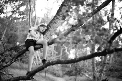 Girl relaxes in a tree.