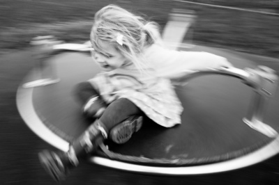 A girl spins in a playground