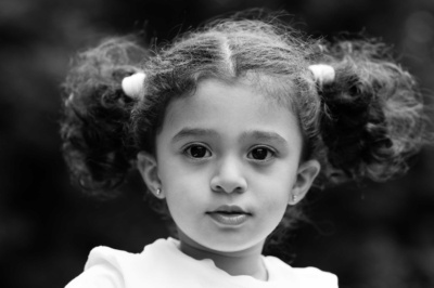 A black and white portrait of a girl with bunches.