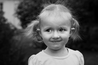 A girl with pigtails smiles at the camera.