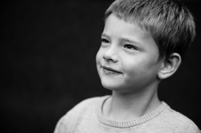 A London close-up black and white portrait of a boy in a jumper.