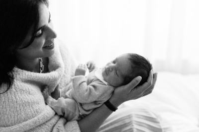 London mother holds sleeping newborn.