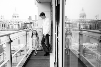 A father and daughter look over the Thames and St Paul's Cathedral during a London photo shoot.