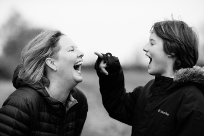 A mother and her son laugh together.