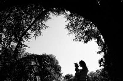 A tree frames and portrait of a mother and baby.