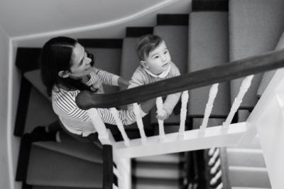 A mother and baby on the stairs.