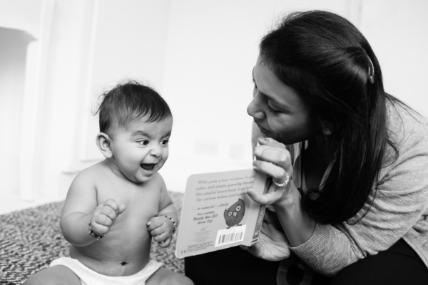 A mother and baby read together.