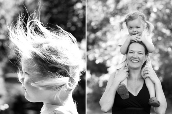 A mother carries her daughter on her shoulders.