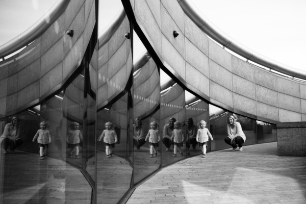 A mother and child reflected in London architecture.