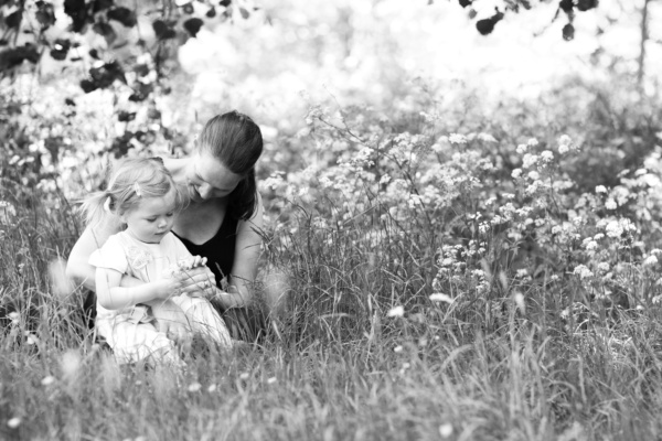 A mother daughter portrait in a field of wildflowers.