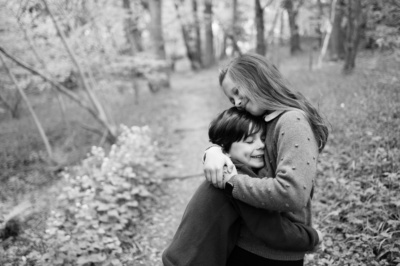 Family hugs in the woods.