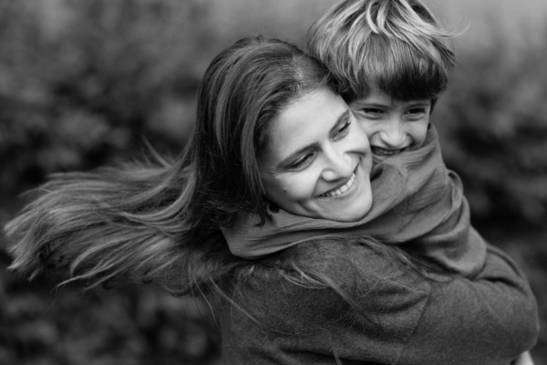 A mother hugs her child during a London portrait session while the family was on vacation in the capital.