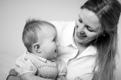 A mother laughs with her daughter.