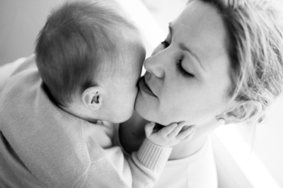 A mother snuggles her baby.