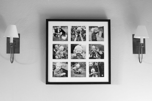 A set of nine family photos in a square with a white mount and black frame.