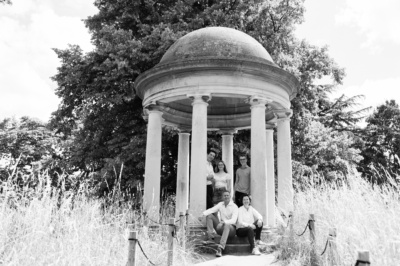 An outdoor family portrait with parents and their three children.