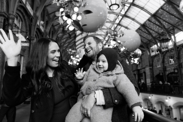 Christmas portraits of parents and their baby at Covent Garden.