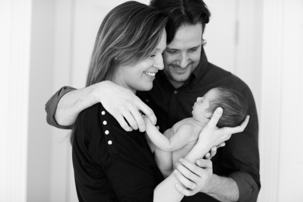 Parents hold their newborn baby.