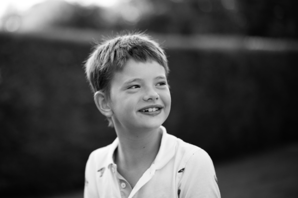 Portrait of a boy in a white shirt.