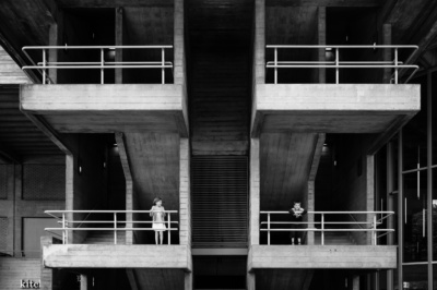 Sibling portrait on brutalist stairs in London.