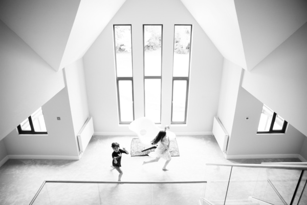 Siblings run through their home.