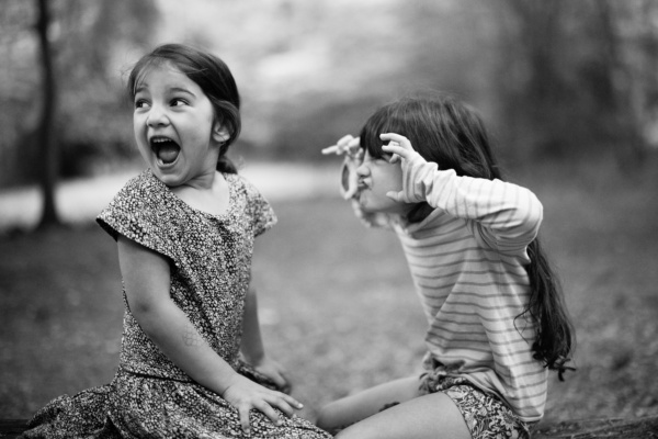 Sisters make scary faces together.