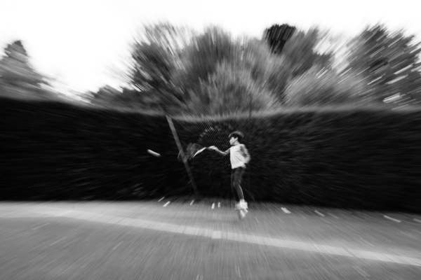 A teenager hits a tennis ball.