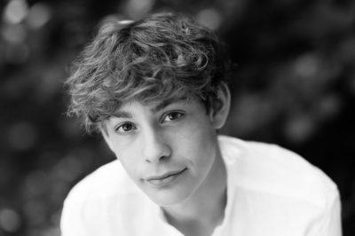 A teenager's black and white headshot.