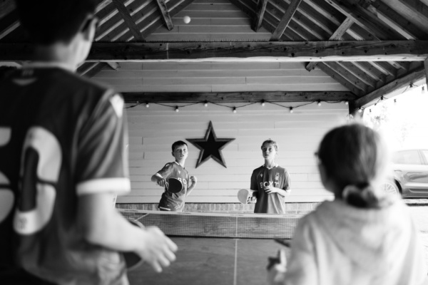 Teenagers play table tennis.