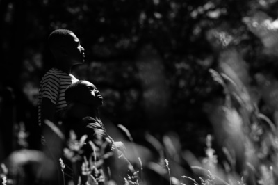 Two siblings look skyward in this woodland portrait.