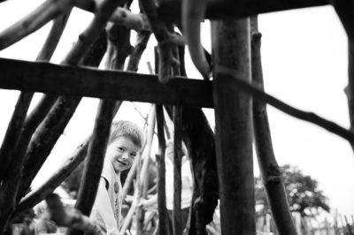 Tree branches frame a portrait of a boy.