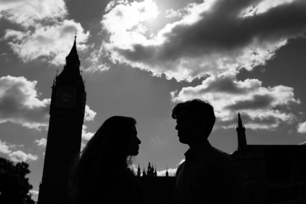 Silhouette of two teens, Big Ben and the houses of parliament.