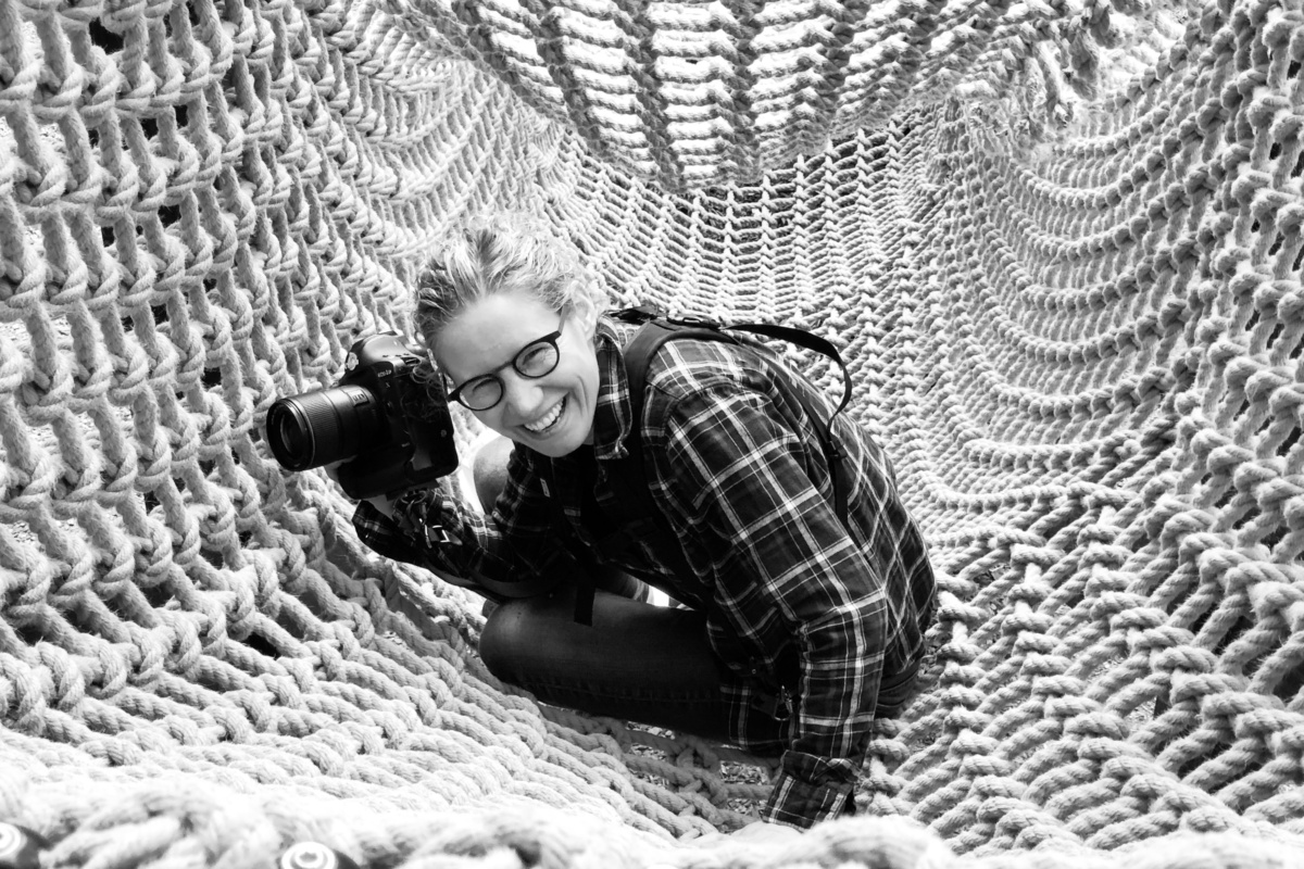 Photographer Helen Bartlett sat laughing in a scramble net tunnel