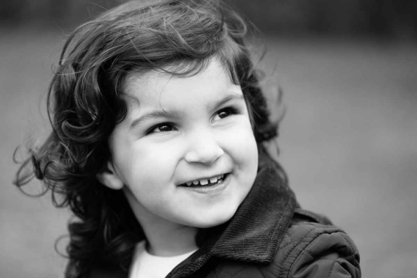 little girl looks up and laughs in beautiful portrait photograph