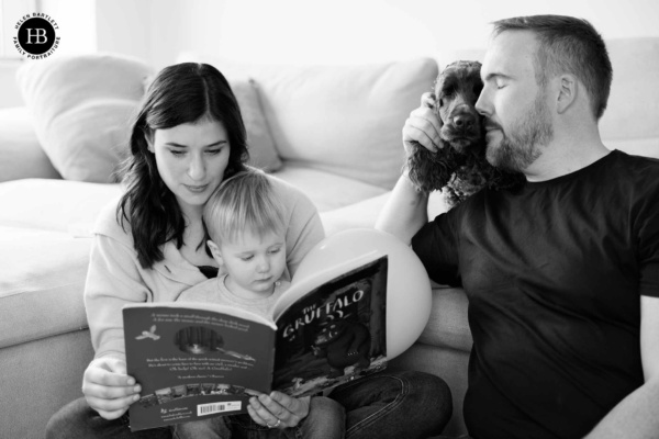 family-reading-together-on-photoshoot-with-dog